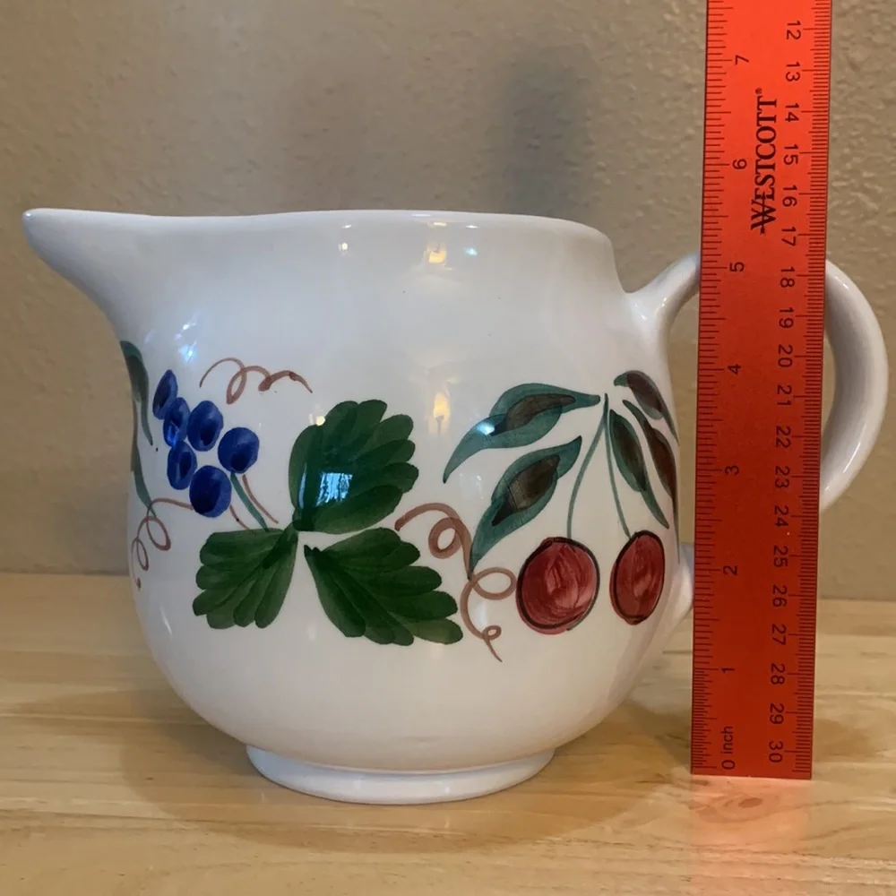 Crate & Barrel white ceramic pitcher hand painted with cherries and grapes.